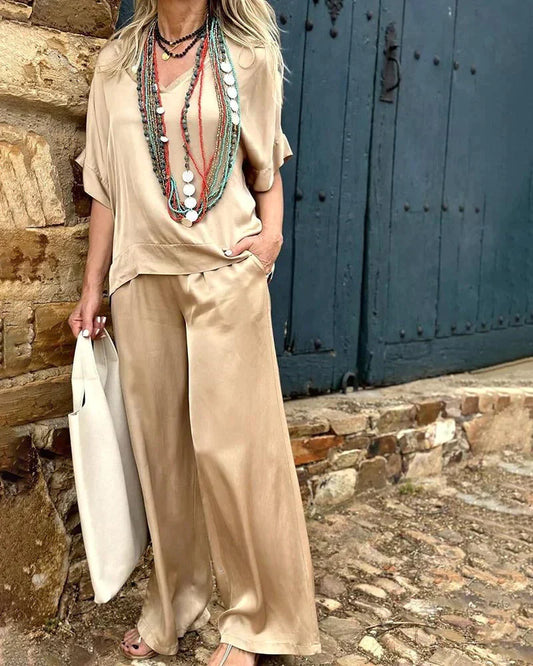 Airelyn - Elegante top bianco con scollo a V e gambe larghe